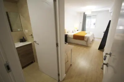 a hotel room with a bed and a bathroom at Apartamento Ross - Central flat with all the amenities in Valencia