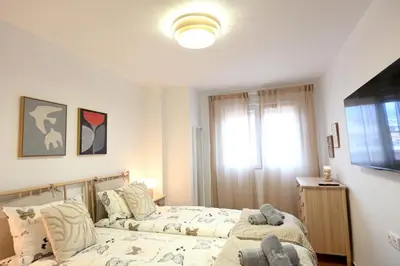 a bedroom with two beds and a window at Vistas al Mar in Puerto de Sagunto