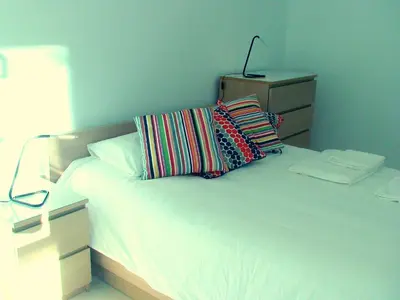 a bedroom with a white bed with pillows and a lamp at Mestalla Silence in Valencia
