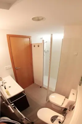 a bathroom with a toilet and a sink and a mirror at Cullera - Primera Línea de Playa in Faro de Cullera