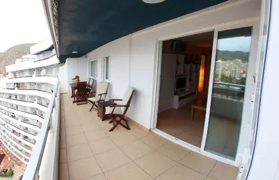a balcony with chairs and a table on a building at Cullera - Primera Línea de Playa in Faro de Cullera