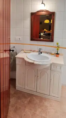 a bathroom with a white sink and a mirror at Casa de invitados en L'Eliana, España in La Eliana