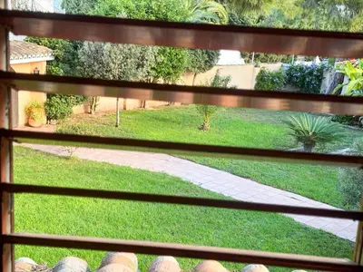 a view of a yard from a window at Casa de invitados en L'Eliana, España in La Eliana