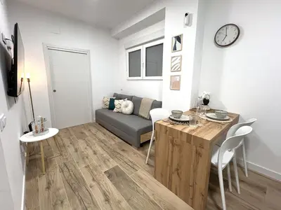 a white kitchen with white cabinets and a microwave at Loft Valencia TR28 - Ground & Arts Connected in Valencia