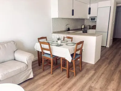 a kitchen and dining room with a table and chairs at Primera línea en playa de Cullera in Cullera