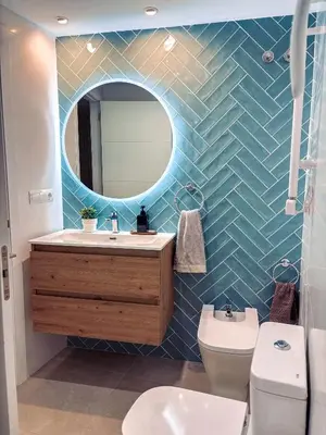 a bathroom with a sink and a mirror and a toilet at Primera línea en playa de Cullera in Cullera