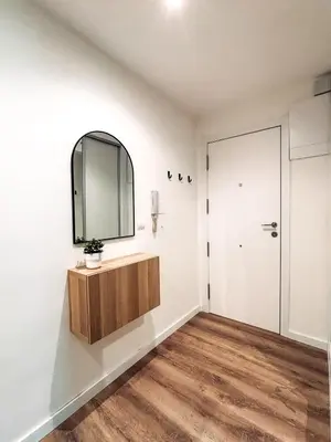 a bathroom with a mirror and a wooden cabinet at Primera línea en playa de Cullera in Cullera