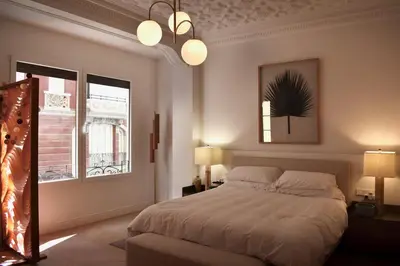 a bedroom with a large bed and two windows at Stylish & Cozy Flat in heart of Eixample, Valencia in Valencia