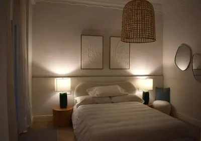 a bedroom with a white bed with two lamps at Stylish & Cozy Flat in heart of Eixample, Valencia in Valencia