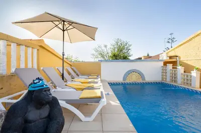 a statue of a gorilla sitting next to a swimming pool at Tiny House Long-term remote work near Valencia in Monserrat