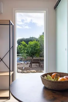 a bowl of fruit on a table in front of a door at Tiny House Long-term remote work near Valencia in Monserrat