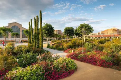 a garden with flowers and trees in a city at Central Home Coliving - vive en la zona de moda del centro de Valencia in Valencia