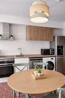 a kitchen with a small table and chairs in it at Central Home Coliving - vive en la zona de moda del centro de Valencia in Valencia