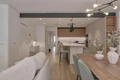 a living room and kitchen with a table and a couch at Luxury Romantic Apartment Mestalla by Virkin Suites in Valencia