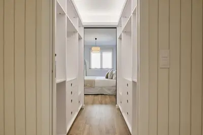 a hallway with white cabinets and a bed in a bedroom at Luxury Romantic Apartment Mestalla by Virkin Suites in Valencia