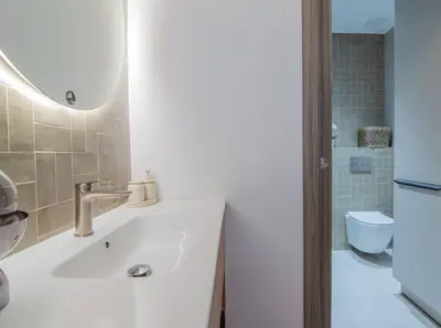 a white bathroom with a sink and a mirror at NOMAD Viveros 02 in Valencia