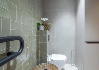 a bathroom with a toilet and a tiled wall at NOMAD Viveros 02 in Valencia
