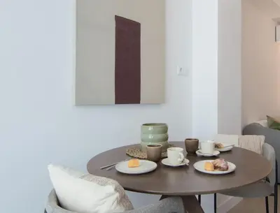a table with two cups and plates of food on it at NOMAD Viveros 02 in Valencia