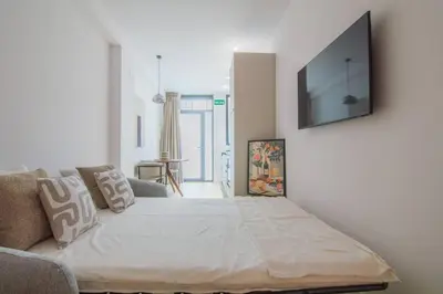 a bedroom with a large bed and a couch at NOMAD Viveros 01 in Valencia