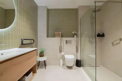 a bathroom with a shower and a toilet and a sink at NOMAD Viveros 01 in Valencia