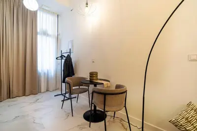 a room with a table and chairs and a mirror at Studio 03 - Les artes in Valencia