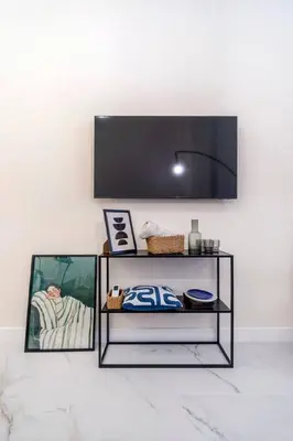 a black shelf with a tv on a wall at Studio 03 - Les artes in Valencia