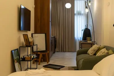 a living room with a green couch and a television at Studio 03 - Les artes in Valencia