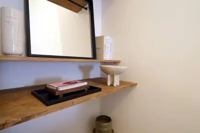 a mirror on a wooden shelf in a bathroom at Studio 01 - Les Artes in Valencia