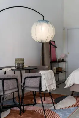 a dining room with a table and chairs and a lamp at Studio 01 - Les Artes in Valencia