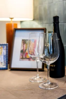 two wine glasses sitting on a table with a bottle of wine at Studio 02 - Les Artes in Valencia