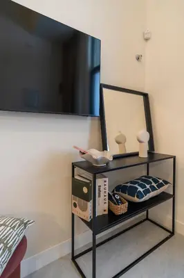 a black shelf with a mirror on a wall at Studio 02 - Les Artes in Valencia