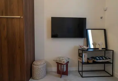 a room with a mirror and a television on a wall at Studio 02 - Les Artes in Valencia