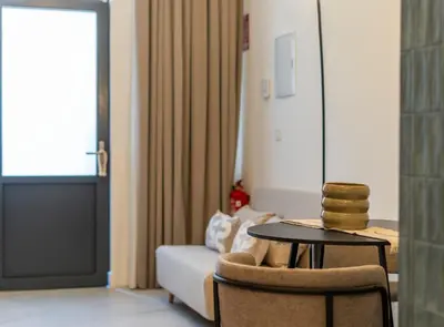 a living room with a couch and a table and a chair at Studio 02 - Les Artes in Valencia