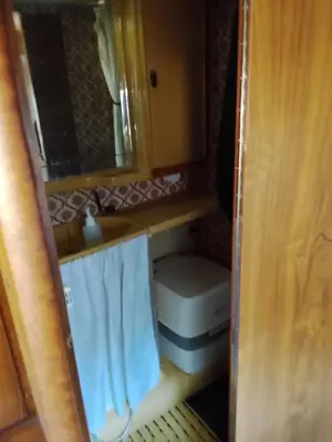 a small bathroom with a sink and a toilet at Autocaravana in Port Saplaya