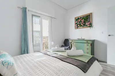 a bedroom with a bed with a dresser and a window at Modern 2BR Apartment with Terrace in Valencia in Valencia