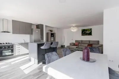 a kitchen and living room with a table and chairs at Modern 2BR Apartment with Terrace in Valencia in Valencia