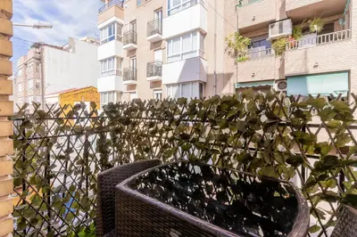 a plant in a basket in front of a fence at Modern 2BR Apartment with Terrace in Valencia in Valencia