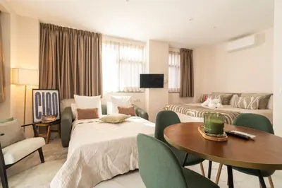 a hotel room with two beds and a table and chairs at República Argentina 02 in Valencia