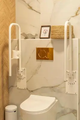 a bathroom with a white toilet and marble walls at República Argentina 02 in Valencia
