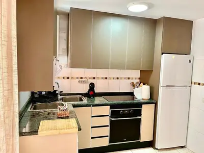 a kitchen with a sink and a refrigerator at Casa Pera in Chilches