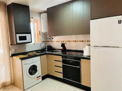 a kitchen with a washing machine and a washer at Casa Pera in Chilches