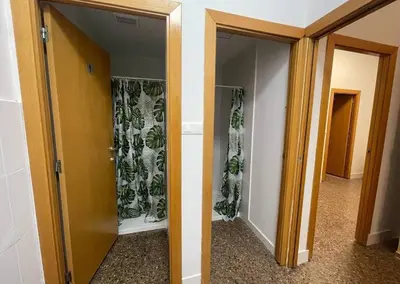 a hallway with two glass doors with plants on them at Hostel valencia ruzafa in Valencia