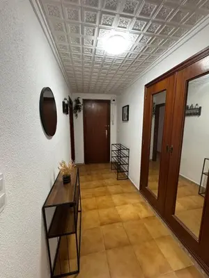 an empty hallway with a table and a door at Albalat Centro in Albalat de la Ribera