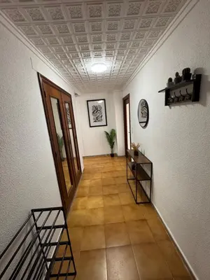 a hallway with white walls and a ceiling with a staircase at Albalat Centro in Albalat de la Ribera