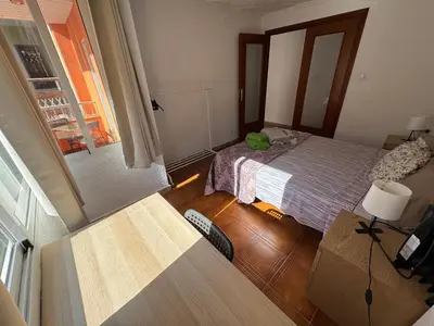 a small bedroom with a bed and a window at Albalat Centro in Albalat de la Ribera