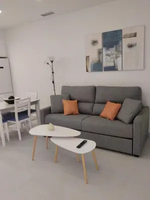 a living room with a couch and a table at Iberflat Apartamentos Alfabega in Paterna