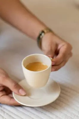 a person holding a cup of coffee on a table at Republica Argentina 1 in Valencia