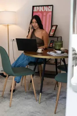 a woman sitting at a table talking on a cell phone at Republica Argentina 1 in Valencia