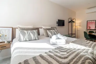 a bedroom with a large white bed with pillows at Republica Argentina 1 in Valencia