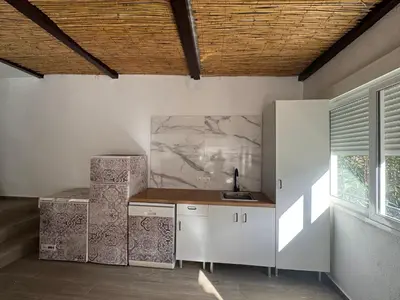 a kitchen with white cabinets and a sink and a window at Chalet Piscina Privada in Barraca de Aguas Vivas